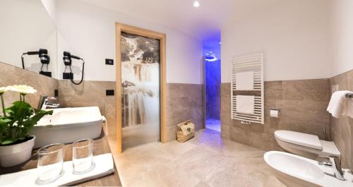 拉维拉Wellness Hotel Gran Risa***S的一间带水槽、卫生间和淋浴的浴室