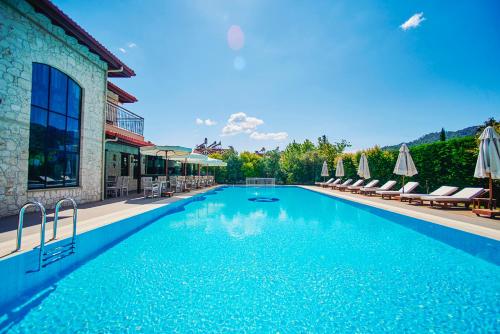 戈西克伦卡酒店及Spa的一个带椅子和遮阳伞的大型游泳池