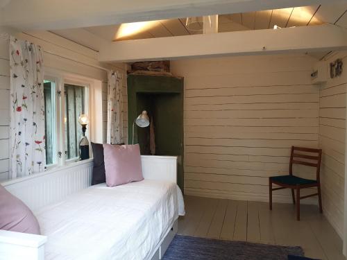 MölntorpWESTERQVARN的卧室配有白色的床和椅子