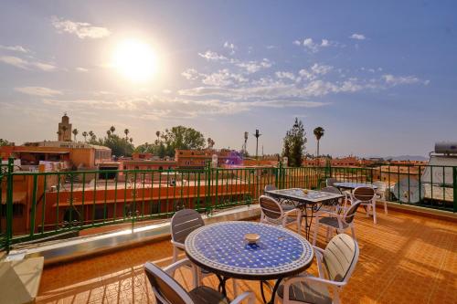 马拉喀什中央宫殿酒店的阳台的天井配有桌椅