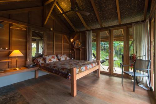 万隆Rumah Lereng Bandung的一间设有床铺的卧室,位于带窗户的房间内