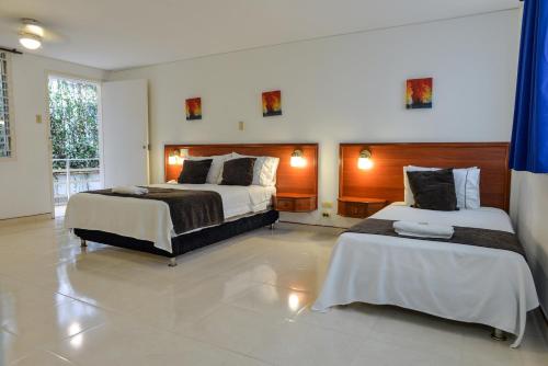 Hotel Thama客房内的一张或多张床位