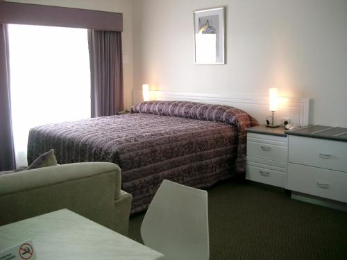 麦克拉伦谷麦克拉伦谷汽车旅馆及公寓的酒店客房配有一张床、一张桌子和一把椅子。