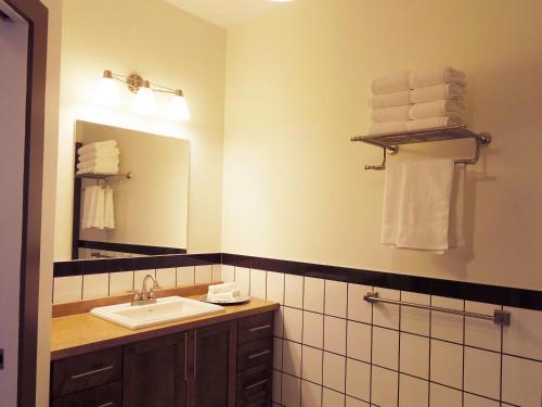 夏洛特顿Water Suites的浴室配有盥洗盆、镜子和毛巾