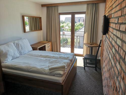 库瑞尼卡慕斯卡Baltik Park的一间卧室设有一张床和砖墙