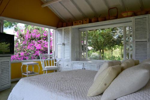 派帕德尔温托别墅度假屋的卧室配有白色的床和2扇窗户。