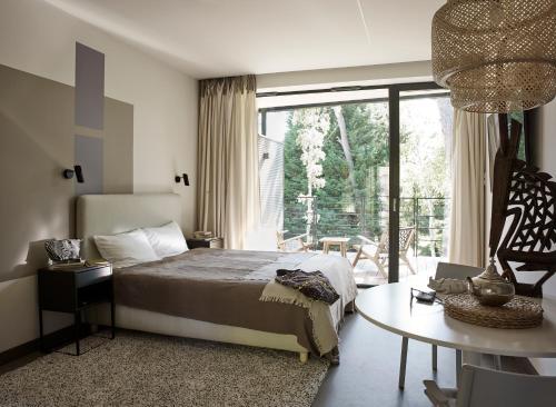 拉塔Apartamenty DECK Jurata的一间卧室配有一张床、一张桌子和一个窗户。