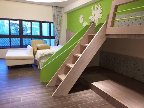 马公美心民宿的客厅设有绿色墙壁的楼梯