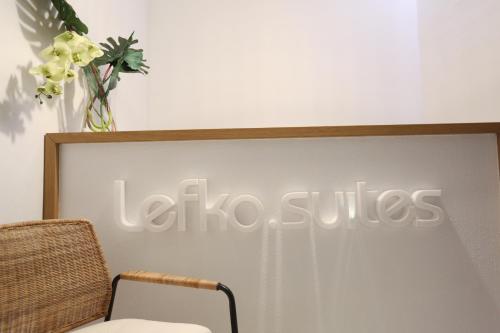 卡尼奥提Lefko Suites的墙上的带椅子的套房标牌