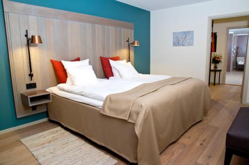 法伦大法伦第一酒店的卧室设有一张大床,拥有蓝色的墙壁