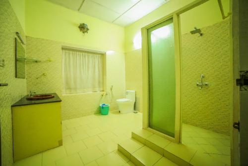 麦帕迪Tea tours Ripon Heritage Bungalow的一间带卫生间和玻璃淋浴间的浴室