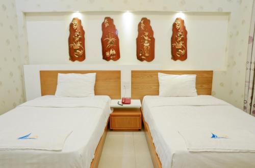 Mui Tau Hotel Phan Ri Cua客房内的一张或多张床位