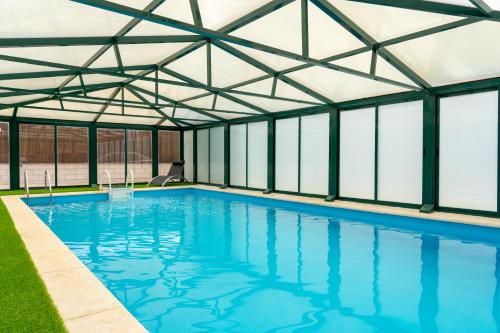 TrescasasEl Mirador de la Atalaya的一个带玻璃屋顶的室内游泳池