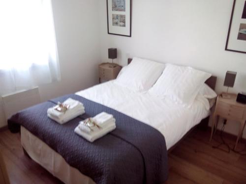 康博莱班BOKATEA的一间卧室配有一张床,上面有两条毛巾