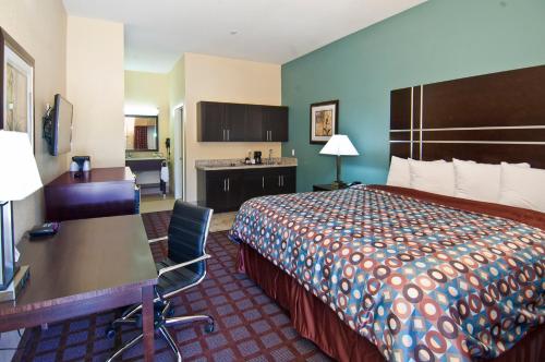 泰勒泰勒行政套房酒店的配有一张床和一张书桌的酒店客房
