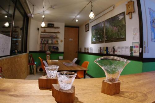 旭川旭川莱德旅馆的木桌边的两瓶玻璃花瓶