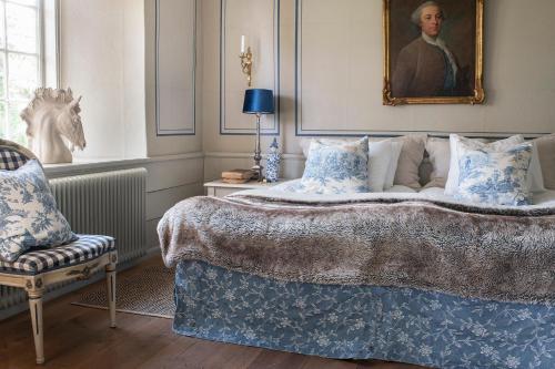 格兰纳维斯塔纳斯洛特酒店的卧室配有一张床和一张男子肖像