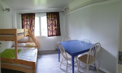 IsfjordenRomsdalseggen Camping的一间带桌子和双层床的用餐室