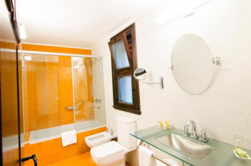 伊瓜苏港Hotel Guaminí Misión的一间带水槽、卫生间和淋浴的浴室