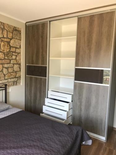 MargarítionPanoraia Maisons的一间卧室配有一张床和一个大衣柜