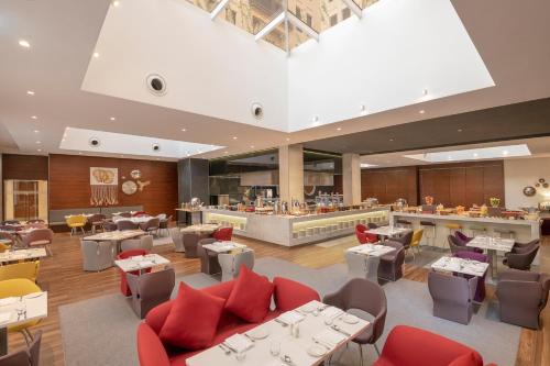迪拜Hyatt Place Dubai Wasl District Residences的一间带桌椅的餐厅和一间酒吧