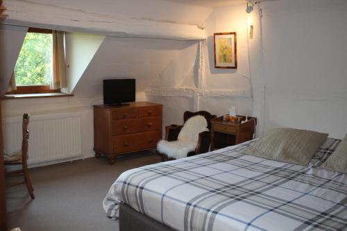FanzelAuberge du Val d'Aisne的一间卧室配有一张床、一张桌子和一把椅子