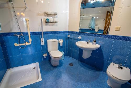 卡斯特罗波尔Casa de Aldea el Ferreirón的蓝色瓷砖浴室设有卫生间和水槽