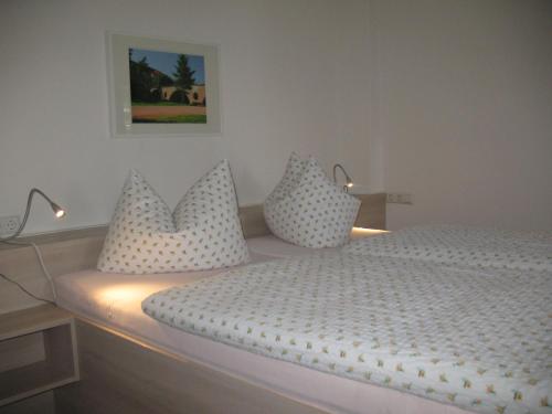 魏玛欣茨昆茨酒店的卧室配有白色的床和枕头。