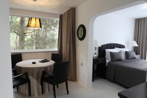 旧扎戈拉希哈塔酒店的酒店客房设有一张桌子、一张床和一个窗户。