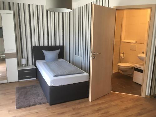 因戈尔施塔特Pension Sonntag Ferienwohnungen的一间小卧室,配有一张床和一个卫生间