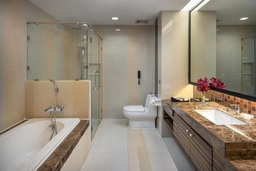 曼谷The Berkeley Hotel Pratunam - SHA Extra Plus的带浴缸、卫生间和盥洗盆的浴室