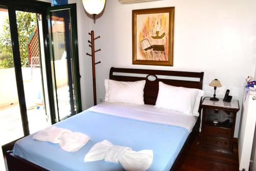 爱琴娜岛Villa Artemis的一间卧室配有蓝色的床和毛巾