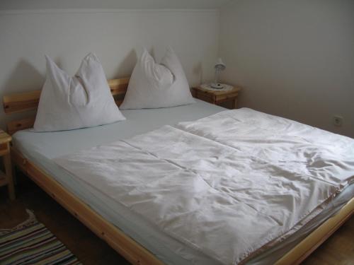 伊伯恩道夫诗纹度假公寓酒店的一张带白色床单和枕头的床