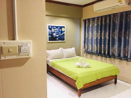 华富里奈特酒店的一间卧室配有一张带绿毯的床和两只兔子