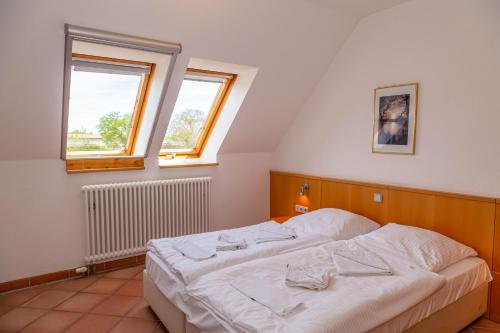 DewichowFerienwohnung Traumurlaub的卧室配有白色床和2扇窗户