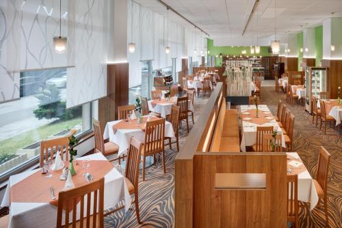 布尔诺阿万蒂酒店的一间带木桌和桌椅的餐厅