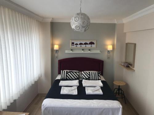 伊斯坦布尔戈吉斯公寓式酒店的一间卧室配有一张带黑白枕头的床