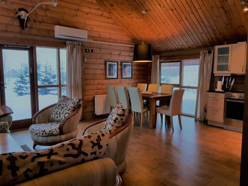 雷克霍特Geysir - Modern Log Cabin的一间带桌子的客厅和一间餐厅