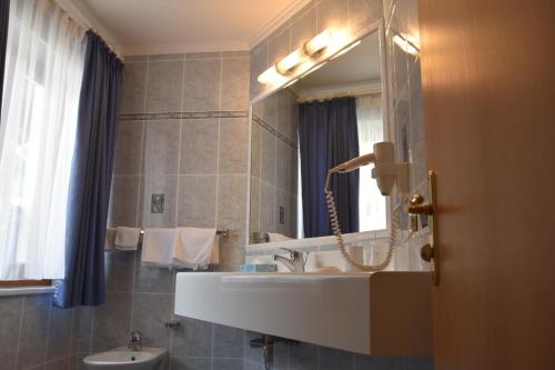 科瓦拉因巴迪亚Garni Haus Tyrol的一间带水槽和镜子的浴室
