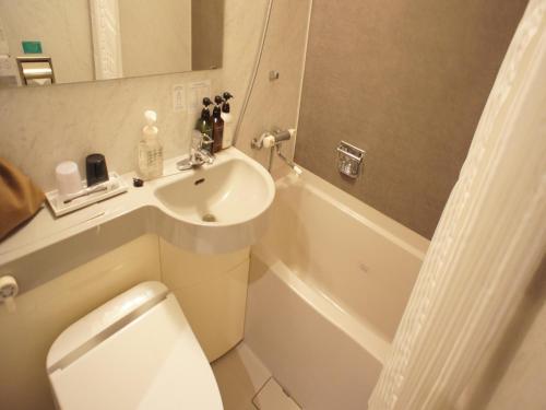 东京新宿西铁酒店的浴室配有盥洗盆、卫生间和浴缸。