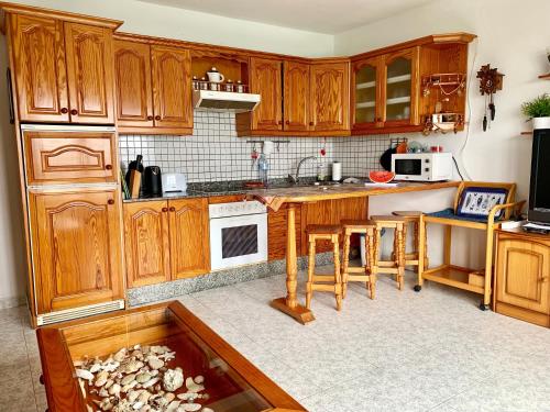 奥尔索拉La Playa的厨房配有木制橱柜和地板上的鱼缸。