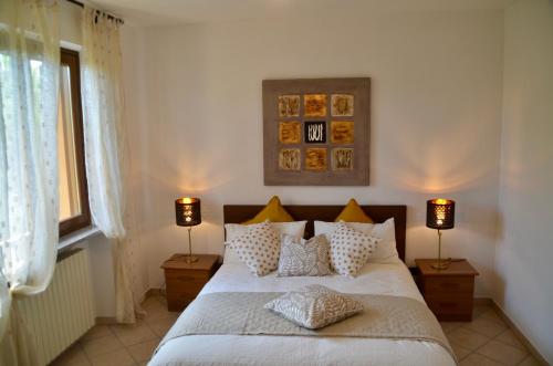 蒙卡尔沃Villa Patrizia的一间卧室配有一张带枕头的床和两盏灯。