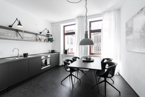 特里尔Casa Augusta - Urban Living的黑白厨房配有桌椅