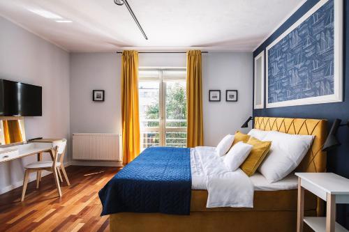 格丁尼亚Villa Orla的一间卧室配有一张床、一张书桌和一个窗户。