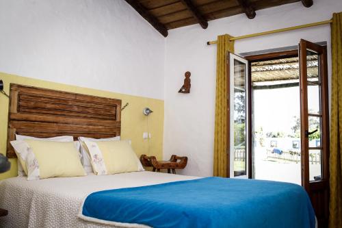 圣特奥托纽塞希拉乡村民宿的一间卧室配有一张带蓝色毯子的大床