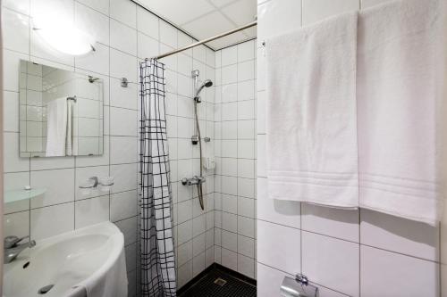 巴勒纳绍布鲁尔斯运动酒店的带淋浴和盥洗盆的白色浴室
