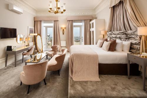 布莱顿霍夫布莱顿海滨美居酒店的酒店客房,配有一张床、一张桌子和椅子