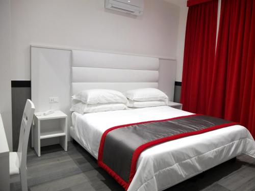 罗马ASTORIA GOLDEN GATE的一间卧室配有一张带红色窗帘的大床