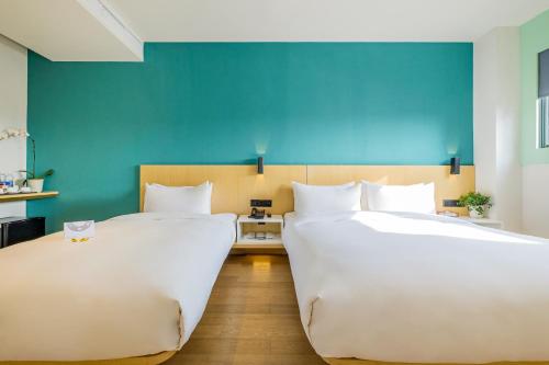 沛喜酒店苏州人民路店客房内的一张或多张床位