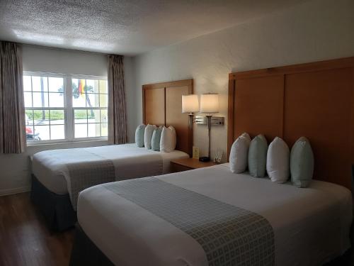 代托纳海滩代托纳海滩1号一室公寓汽车旅馆的酒店客房设有两张床和窗户。